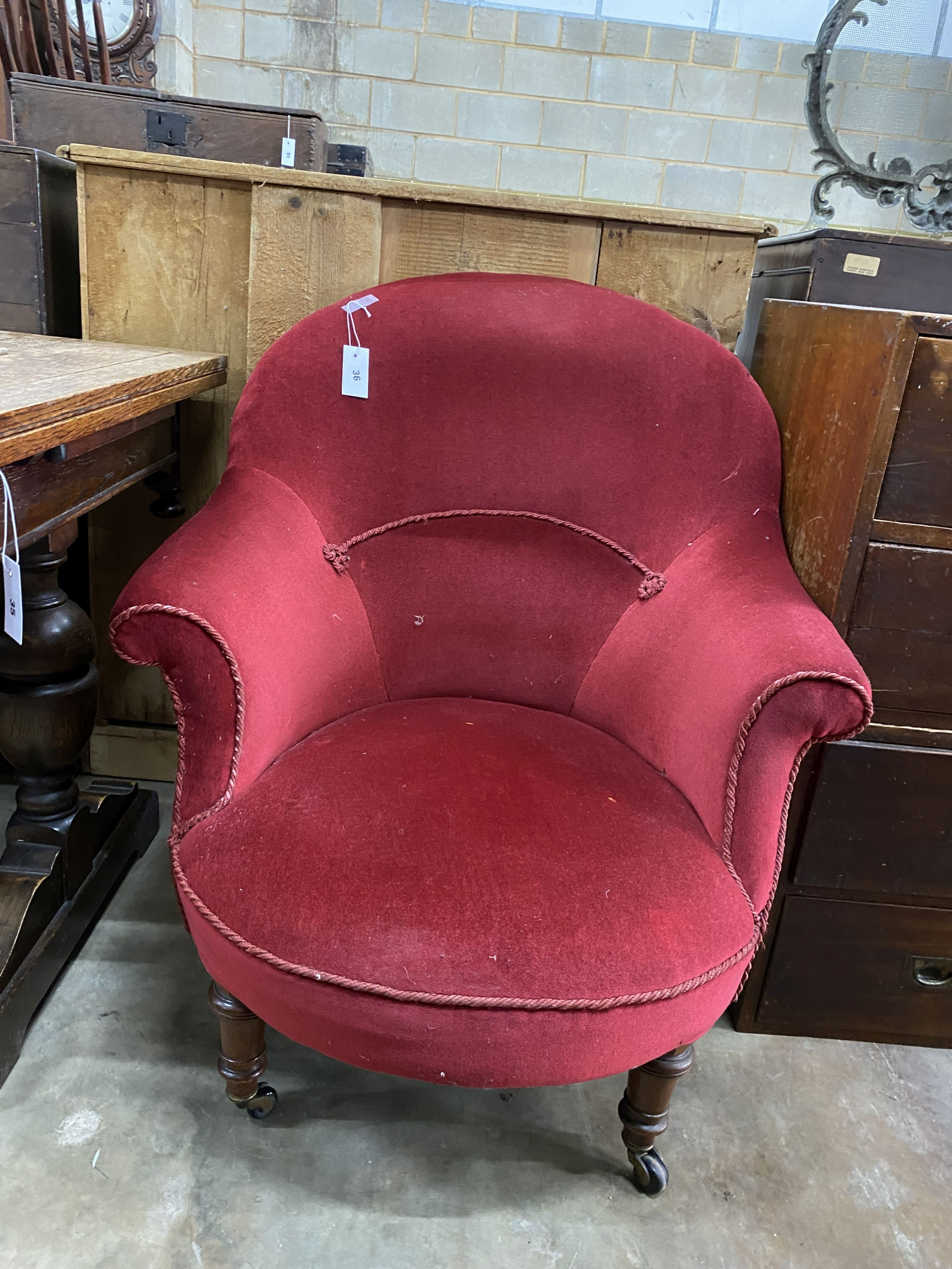 A late Victorian nursing chair upholstered in red dralon, width 78cm, depth 80cm, height 92cm